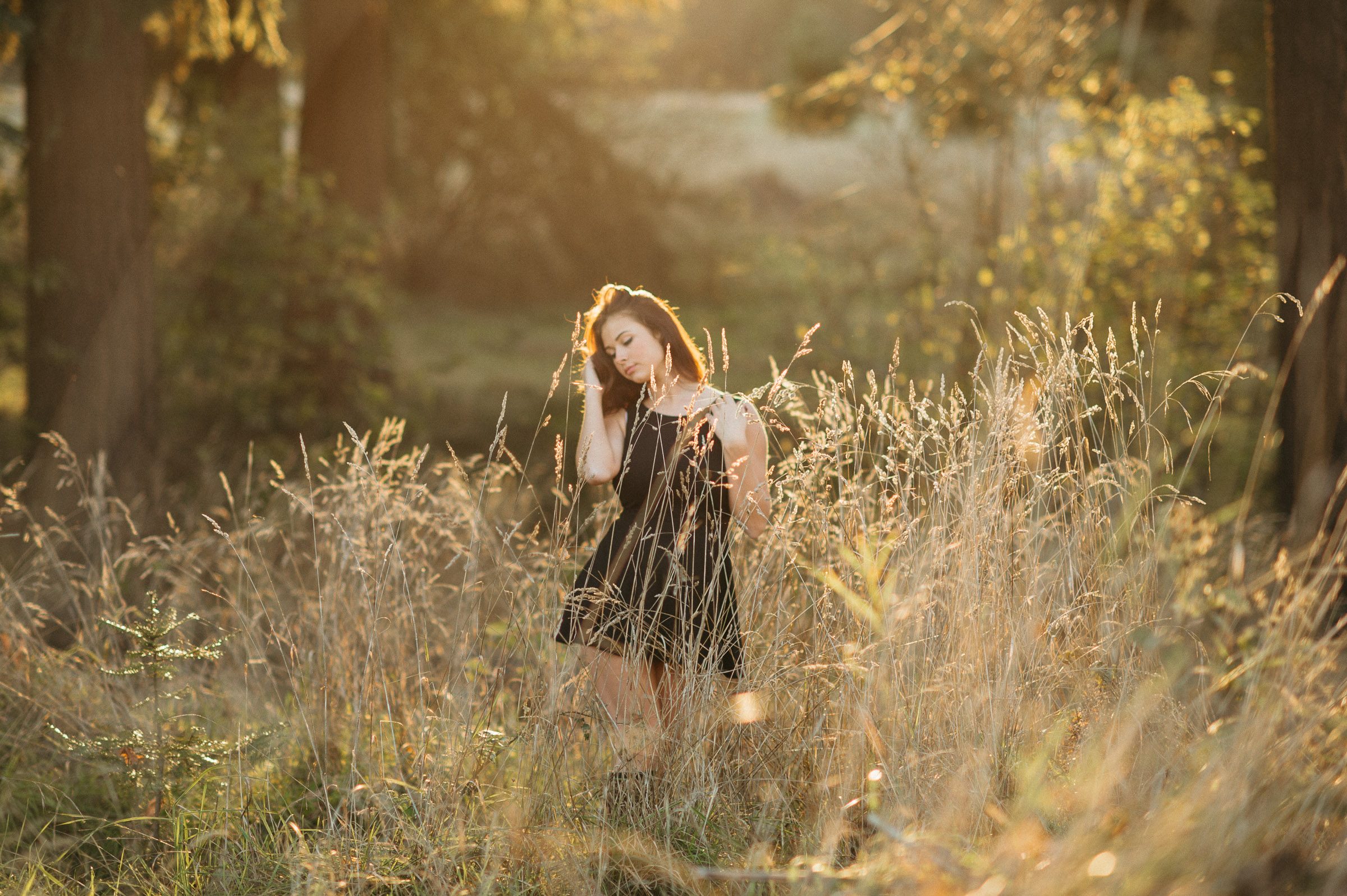 High school senior portrait in the evening glow of Discovery Park in Seattle.