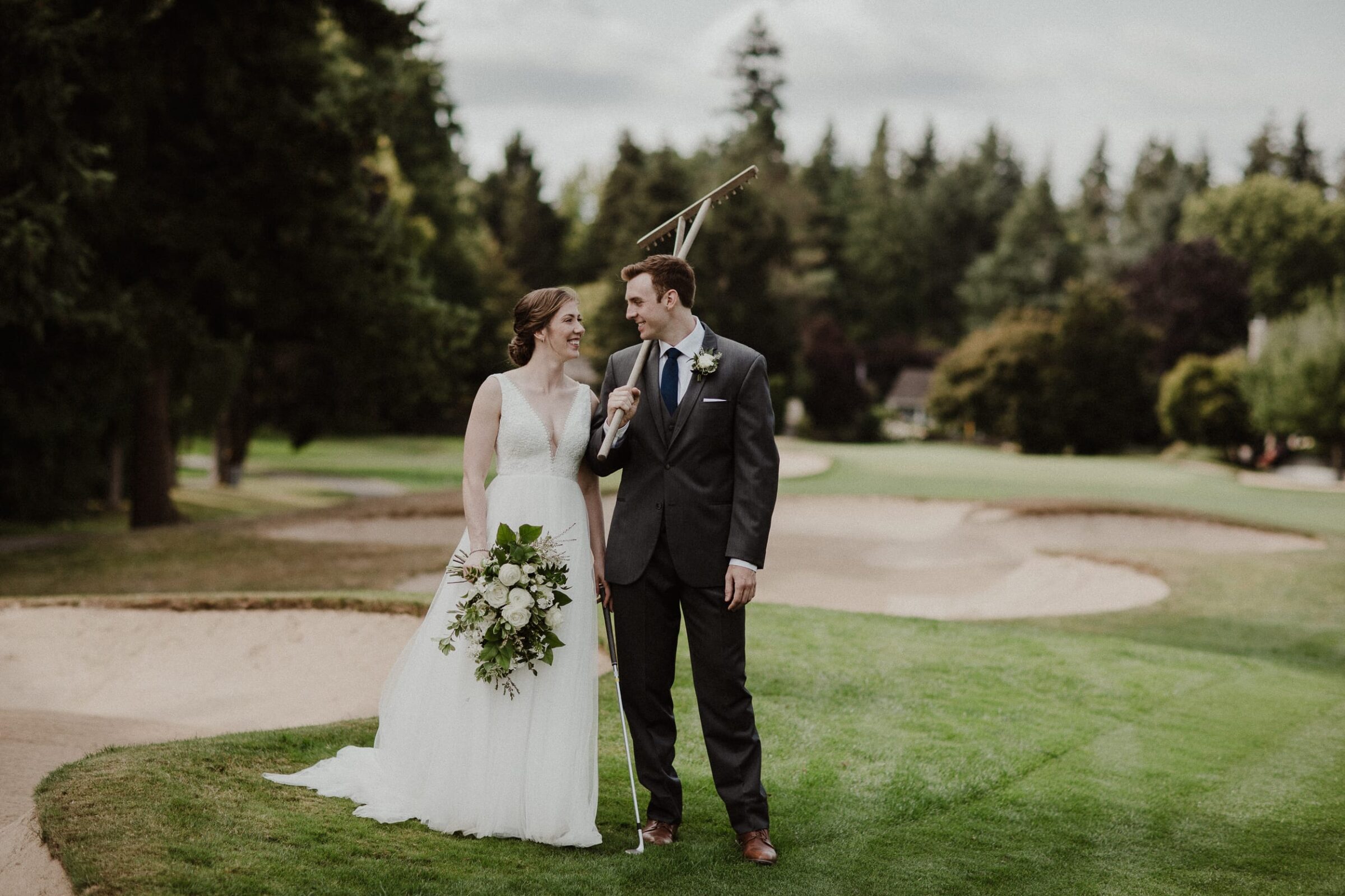 Wedding couple smiling on golf course in Seattle.