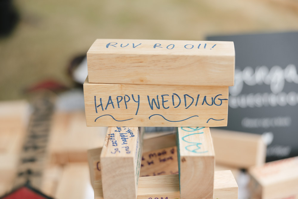 Blocks of wood with wedding messages written by guests on the surface.