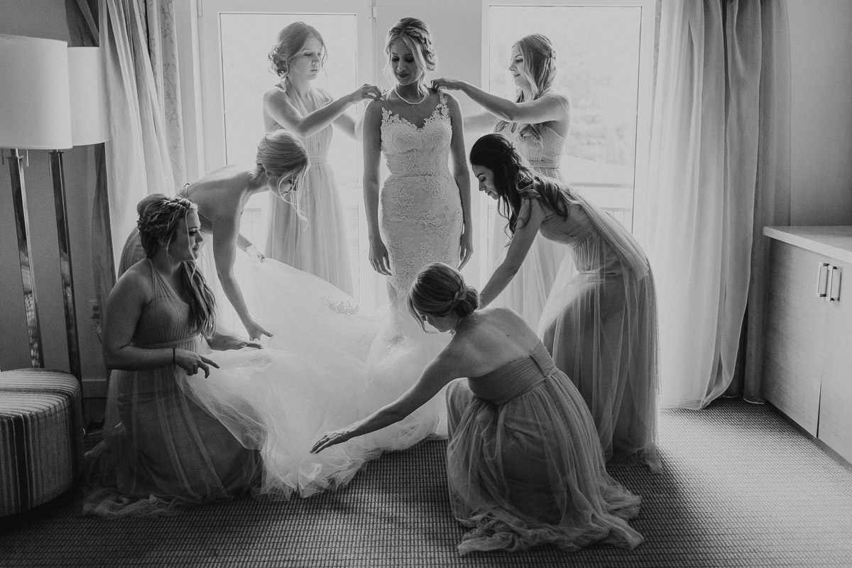 Bride preparing with bridesmaids in elegant room